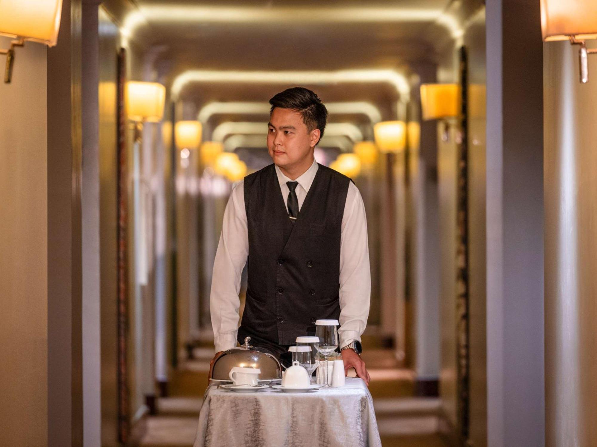 Fairmont Makati Hotel Makati City Екстериор снимка A room service attendant at work